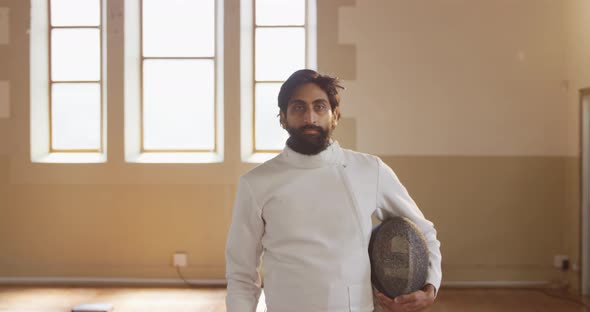 Fencer athlete during a fencing training in a gym