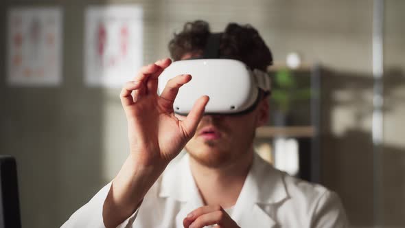 Young Man Doctor Conducting Experimental Medical Procedure Wearing Virtual Reality Headset