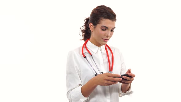 Portrait of a Young Nurse Using Her Smartphone to Text Messages