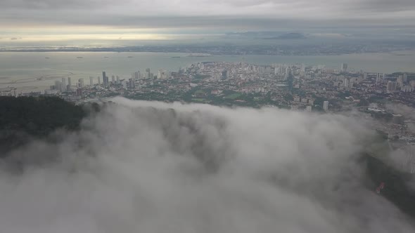 Aerial view over low cloud at tropical rainforest.