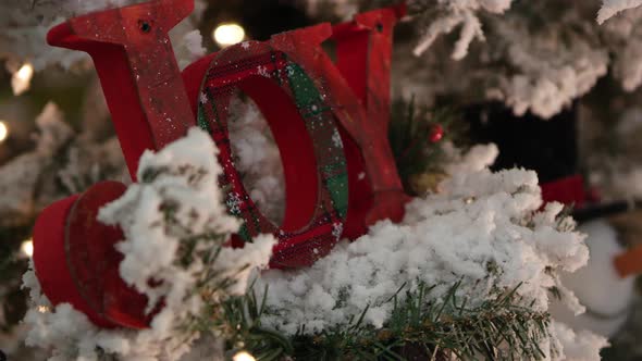 Up close view of wooden joy sign on flocked christmas tree