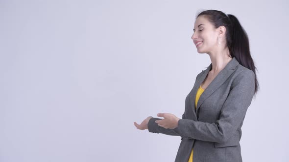 Happy Young Beautiful Businesswoman Showing Something To the Back