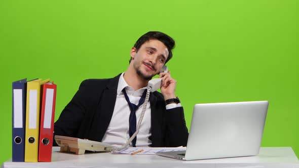 Man Relaxed Calls on the Phone From Office, Green Sreen