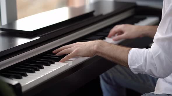 In piano lessons for adults, a pianist plays a melody on the piano.