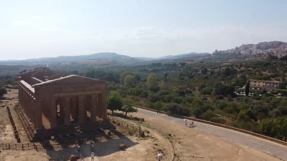 People Visiting The Famous Temple of Concordia In The Valley Of The Temples In Agrigento, Sicily, It