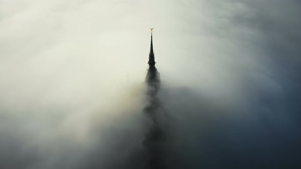 Atmospheric Aerial Shot, Thick Fog Clouds Flow Covering Famous Majestic Mont Saint Michel Fortress