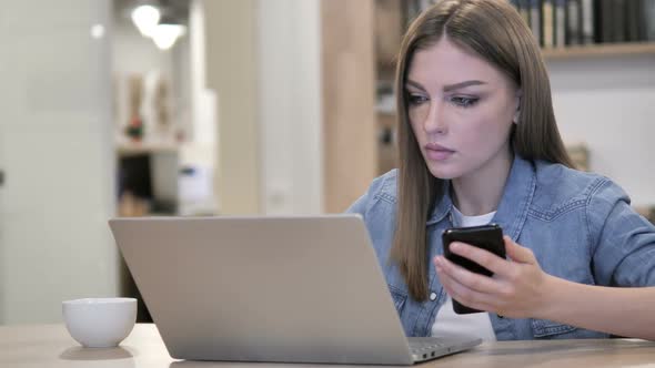 Creative Woman Working with Smartphone and Laptop