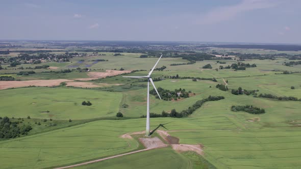 Aerial view of windmills farm for energy production on beautiful cloudy sky at highland. Wind power 