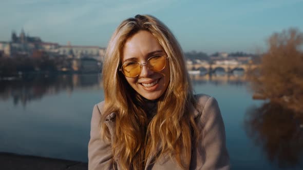 Cool and Moody Portrait of Beautiful Young Woman in Sunglasses Looking Into Camera in Slow Motion in