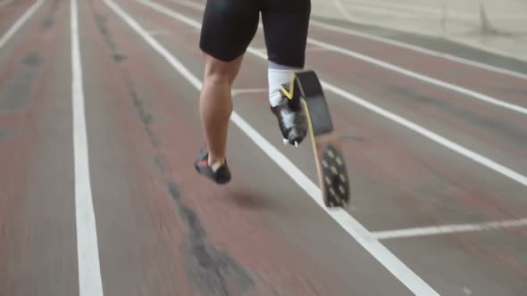 Paralympic Athlete Running on Track