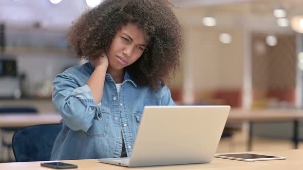 Tired African Woman Having Neck Pain at Work 