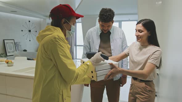 Young Latin Couple Getting Pizza Delivery