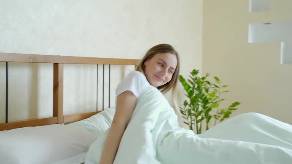 Woman Waking Up in Her Bed Fully Rested