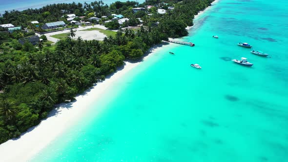 Wide angle flying clean view of a white sand paradise beach and blue water background in hi res 4K