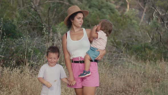 Friendly Family Goes Hand in Hand on a Walk in the Park