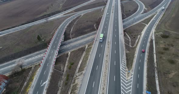 Aerial high drone flight over Highway and overpass. Road junction.