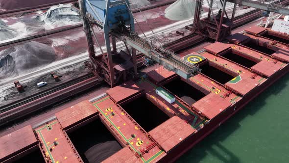 Bulk Carrier Ship Offloading Cargo By Crane for Processing
