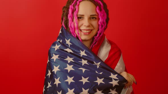 Young woman, with American flag on red background.