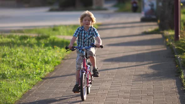 Blond Boy Riding on the Kids Bike alt