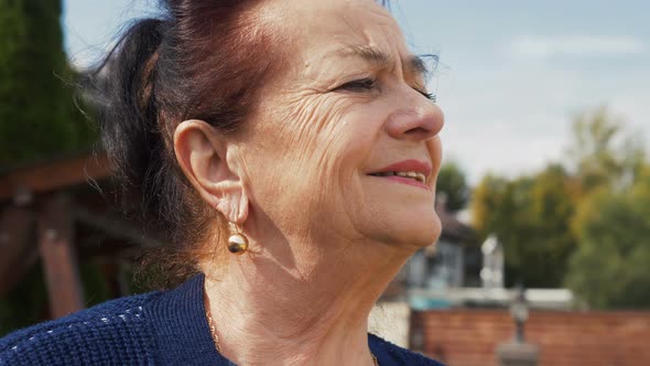 portrait of old caucasian woman, what looking dreamily into the distance, remembering the best years