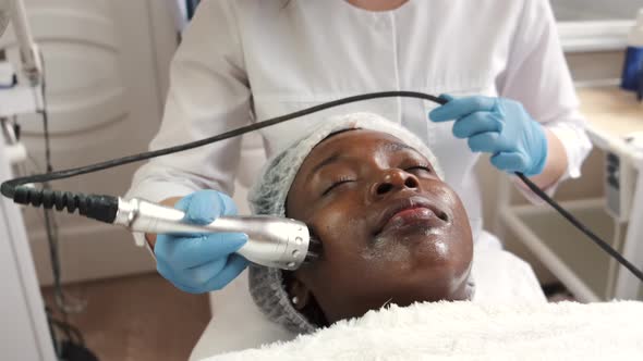 Beautician Makes Procedure for Clean Face with Hardware