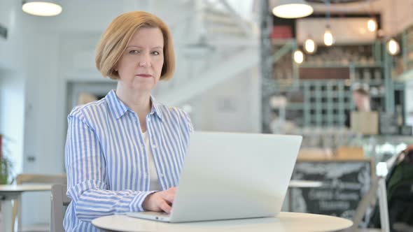 No, Finger Gesture By Creative Old Woman with Laptop in Cafe 