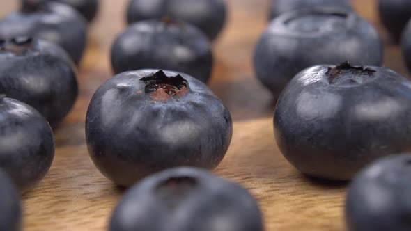 Fresh blueberries on a wooden texture.