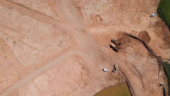 Excavator Loading Sand Into Large Truck Aerial View