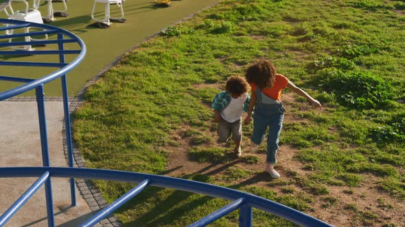 Mother and son having fun at playground