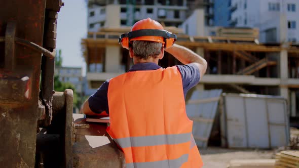 Middleaged Foreman at Construction Site Analyzing