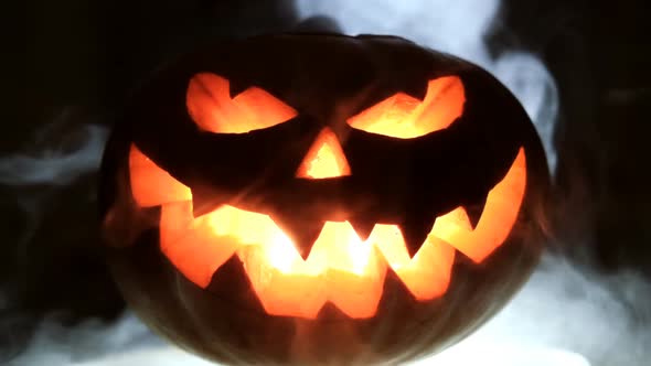 Halloween Pumpkin in Mist At Night . Slow Motion.