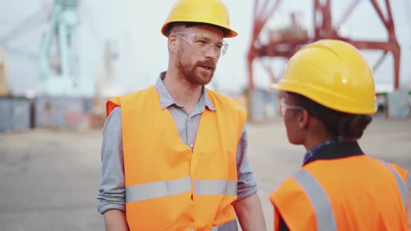 Cheerful engineers discussing a working project