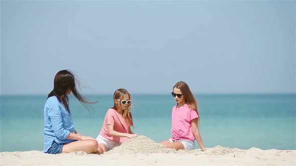 Beautiful Mother and Daughter at Beach Enjoying Summer Vacation