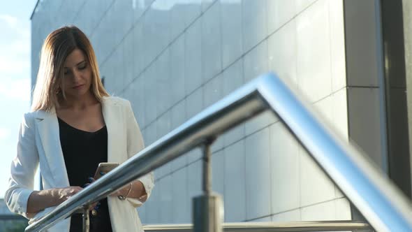 Beautiful Business Lady Is Reading a Message in a Smartphone.