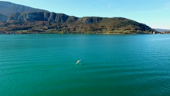 A kayaker paddles in a scenic mountain lake.