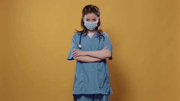 Portrait of Woman Doctor with Arms Crossed Posing Confident Wearing Covid Protection and Stethoscope