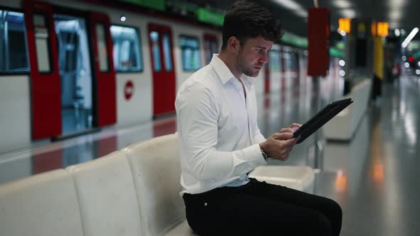 Male Entrepreneur with Tablet in Subway