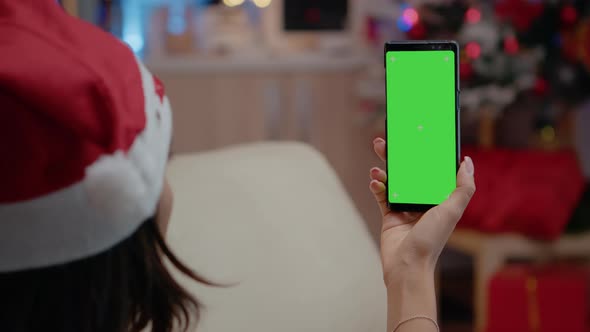 Close Up of Adult Vertically Holding Smartphone with Green Screen