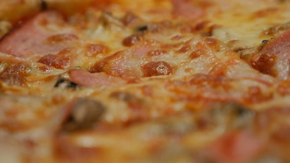 Baked pepperoni cheese pizza close-up texture 4K 2160p 30fps UltraHD footage - Tasty Italian traditi