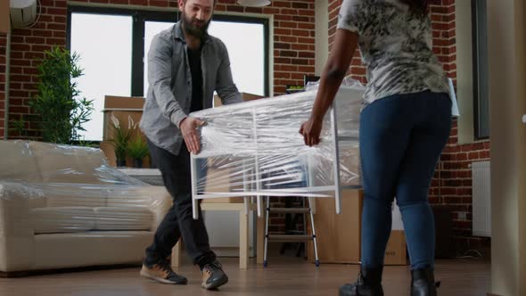 Homeowners Couple Decorating Apartment Flat with Furniture After Moving in