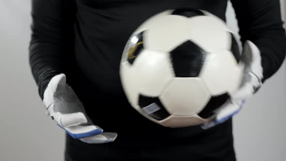 Close Up Goalkeeper Holding Soccer Ball in the Stadium Studio Football Player Hands Professional