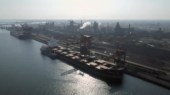 Bulk Carrier Ship Offloading Cargo at an Industrial Port in Europe