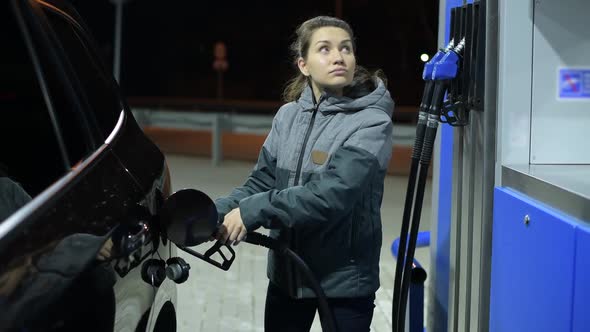 girl completed refueling her car with diesel and closes the gas tank
