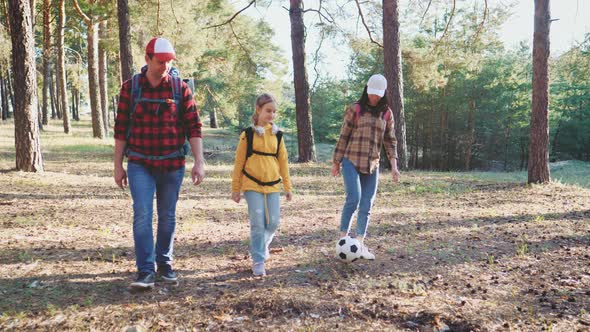 Happy Family Hiking Through a Forest