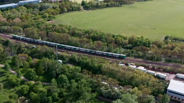 slider drone shot following southern railway class 377 train through north west London