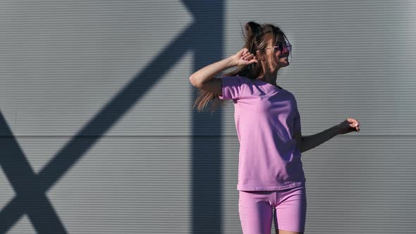 Funky Street Dancer Female Demonstrate Dance Movement at Metallic Wall