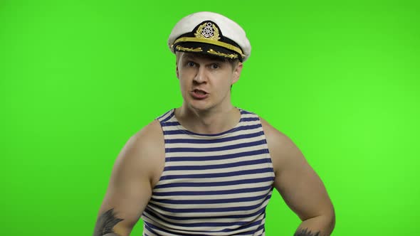 Young Sailor Man Is Angry and Shows Fist Fight. Seaman Guy in Sailor's Vest