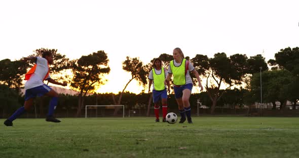 Female soccer player getting tackled down by competition. 4k