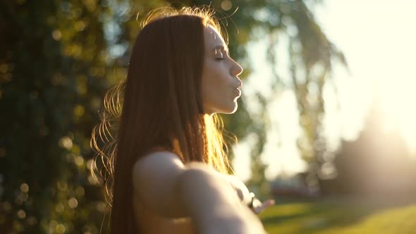 Closeup Face with Closed Eyes of Woman Standing with Hands Divorced To Side and Deeply Breathing