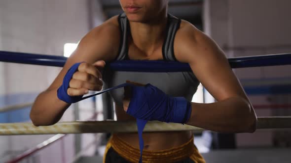 Mixed race woman wrapping her hands